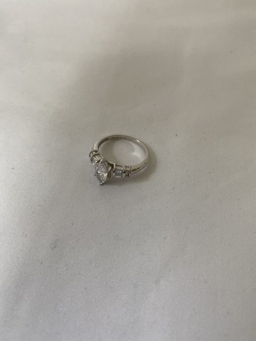Sterling Silver Ring With One Large And Four Smaller Clear Stones, Size 8 from an estate, in “as found” condition. We have not cleaned or polished this item. Marked 925. Nice Ring.