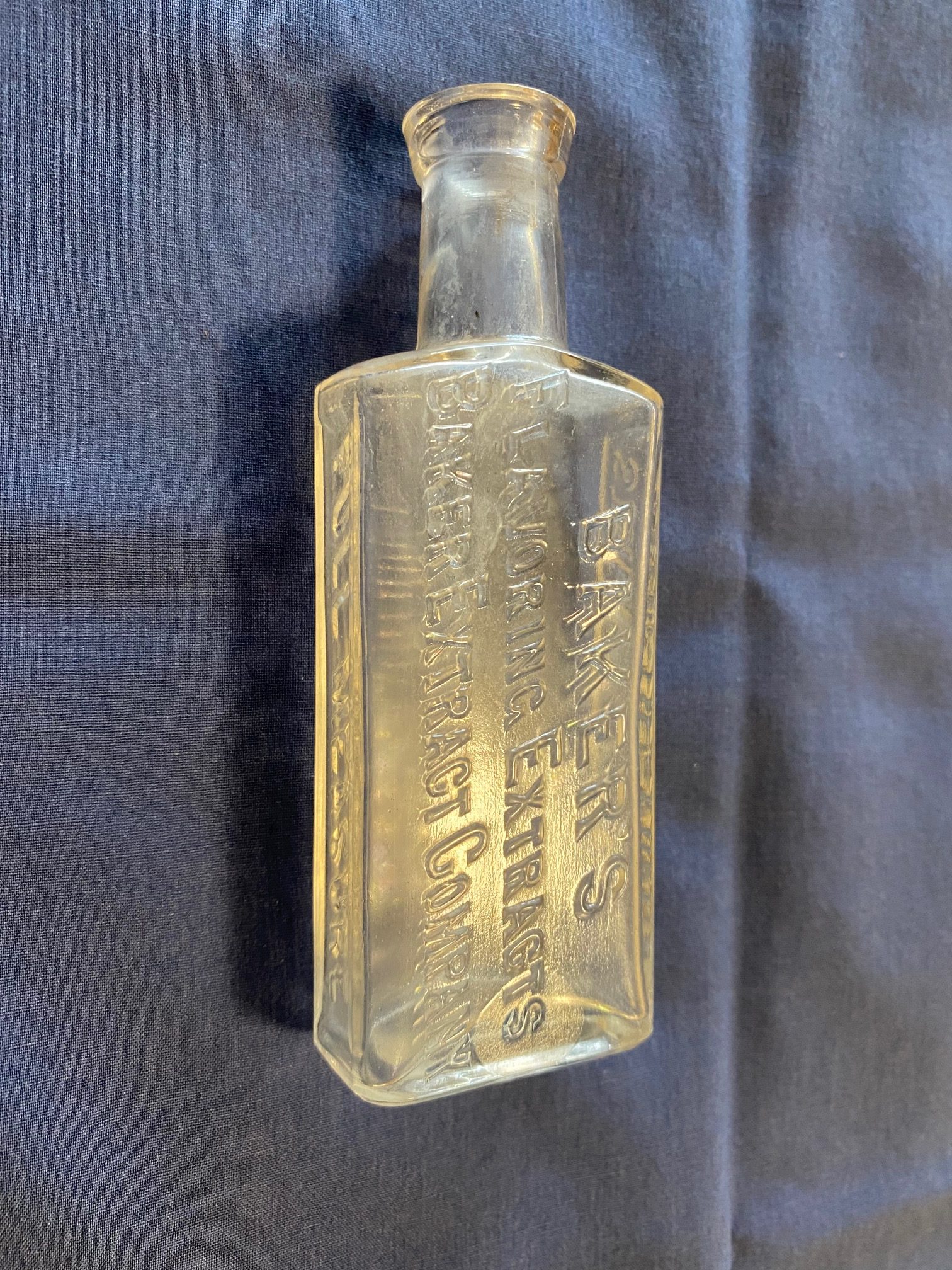 Antique Embossed Baker’s Flavoring Extracts Company Clear Glass Bottle