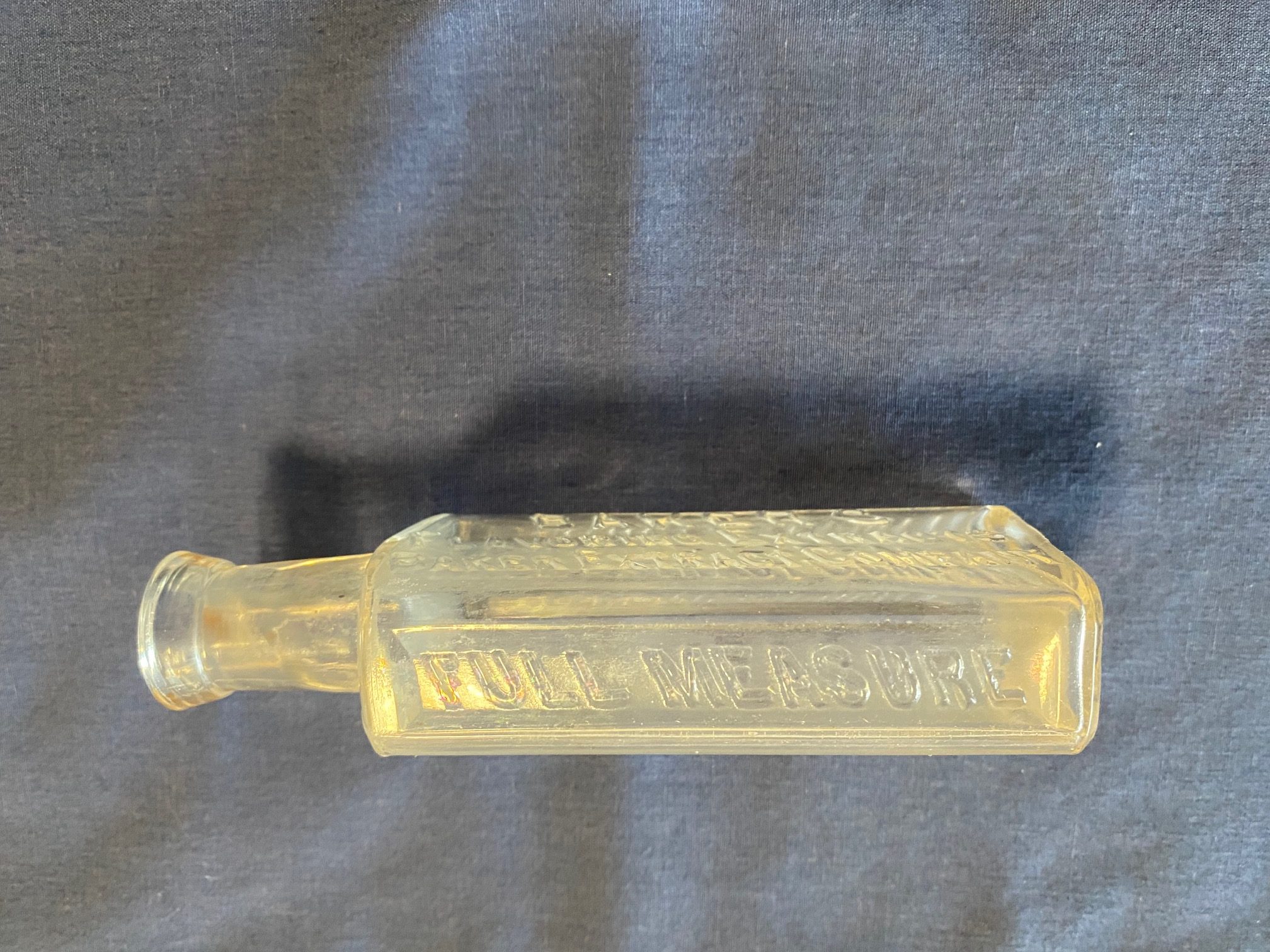 Antique Embossed Baker’s Flavoring Extracts Company Clear Glass Bottle